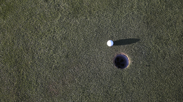 aerial view of golf ball on golf course green